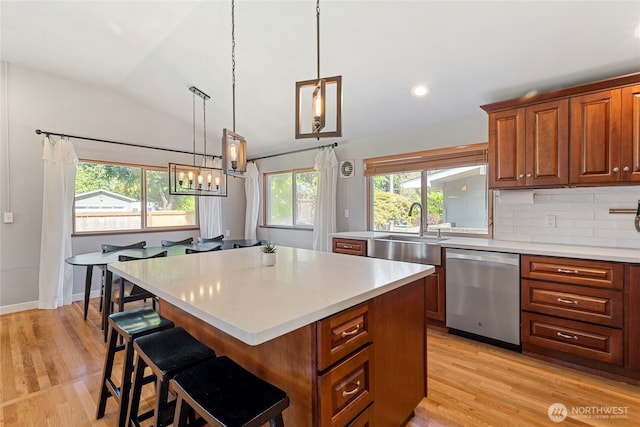 922 SW 160th St, Burien, WA 98166 - kitchen with lofted ceiling, stainless steel dishwasher, light countertops, light wood finished floors, and a kitchen island