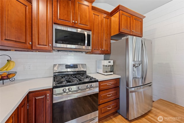 922 SW 160th St, Burien, WA 98166 - kitchen with stainless steel appliances, light countertops, light wood-type flooring, and tasteful backsplash