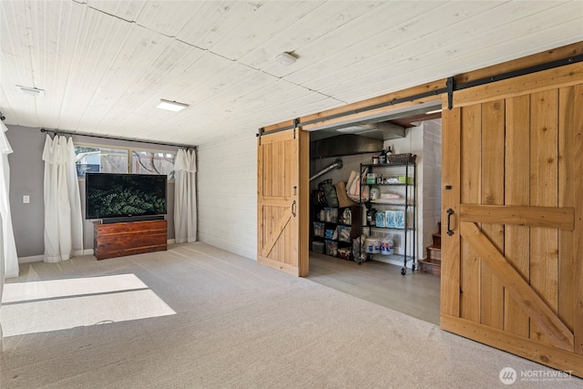 922 SW 160th St, Burien, WA 98166 - basement featuring a barn door, carpet flooring, wooden walls, and wooden ceiling