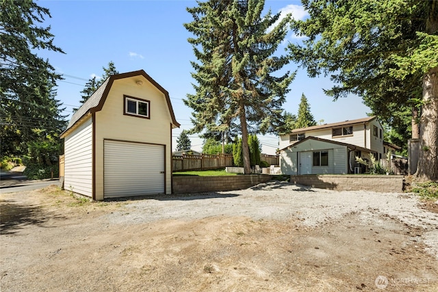 922 SW 160th St, Burien, WA 98166 - view of front of home with a garage, an outdoor structure, a gambrel roof, and driveway