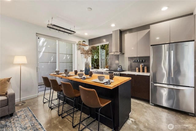 1804 25th Ave Unit A, Seattle, WA 98122 - kitchen with stainless steel appliances, concrete flooring, wooden counters, a kitchen breakfast bar, and a center island