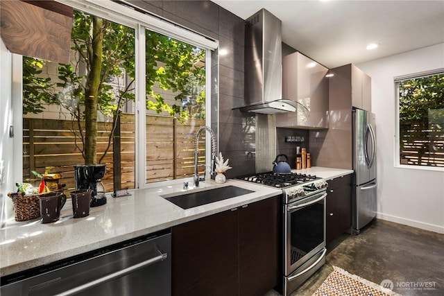 1804 25th Ave Unit A, Seattle, WA 98122 - kitchen featuring appliances with stainless steel finishes, wall chimney exhaust hood, backsplash, modern cabinets, and finished concrete flooring