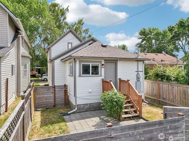 1022 N Anderson St, Tacoma, WA 98406 - back of property with a shingled roof, a fenced backyard, and a patio area