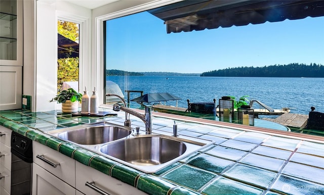 18 Holly Ln, Mercer Island, WA 98040 - kitchen featuring tile countertops, a water view, and glass insert cabinets
