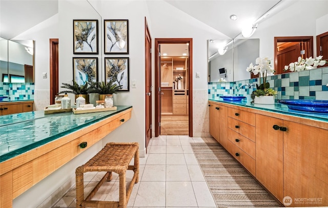 18 Holly Ln, Mercer Island, WA 98040 - bathroom with lofted ceiling, vanity, tile patterned flooring, tile walls, and tasteful backsplash