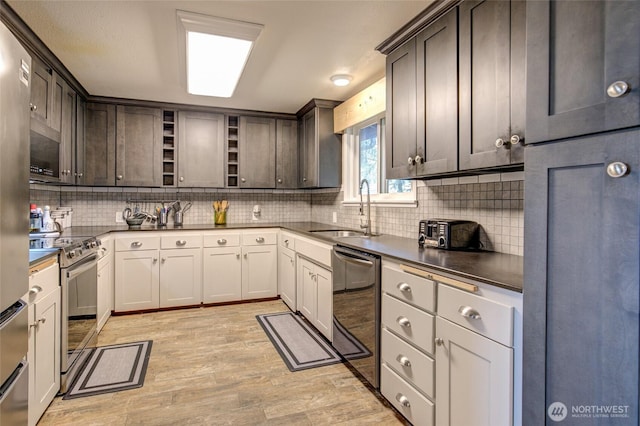 717 Judith Ct, Aberdeen, WA 98520 - kitchen featuring appliances with stainless steel finishes, backsplash, light wood finished floors, and dark brown cabinets