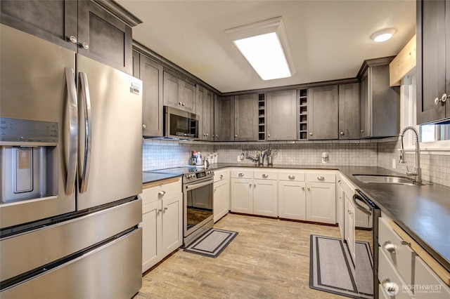 717 Judith Ct, Aberdeen, WA 98520 - kitchen with appliances with stainless steel finishes, open shelves, light wood-style flooring, backsplash, and dark countertops