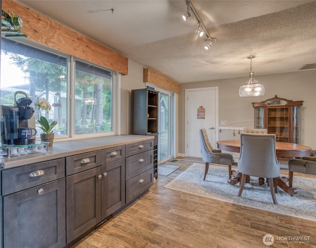 717 Judith Ct, Aberdeen, WA 98520 - dining area with track lighting, light wood-style flooring, and a textured ceiling