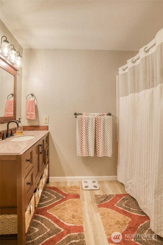 717 Judith Ct, Aberdeen, WA 98520 - bathroom with vanity, wood finished floors, and curtained shower