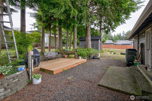 717 Judith Ct, Aberdeen, WA 98520 - fenced backyard with a storage unit and a deck