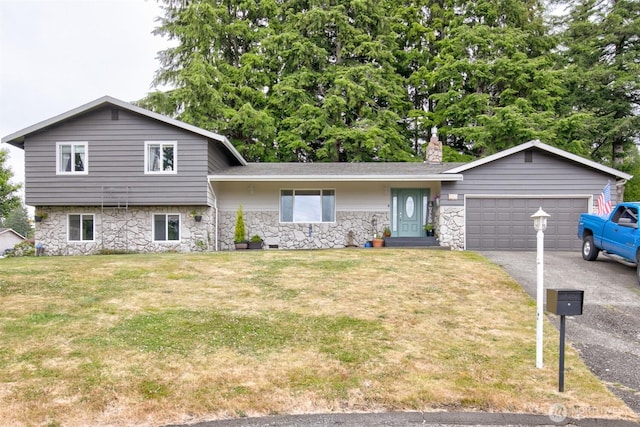 717 Judith Ct, Aberdeen, WA 98520 - split level home with stone siding, asphalt driveway, a garage, and a front lawn