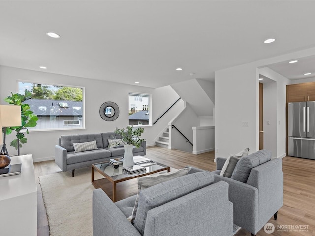 9015 Dibble Ave NW, Seattle, WA 98117 - living area with healthy amount of natural light, stairs, light wood-style floors, and recessed lighting