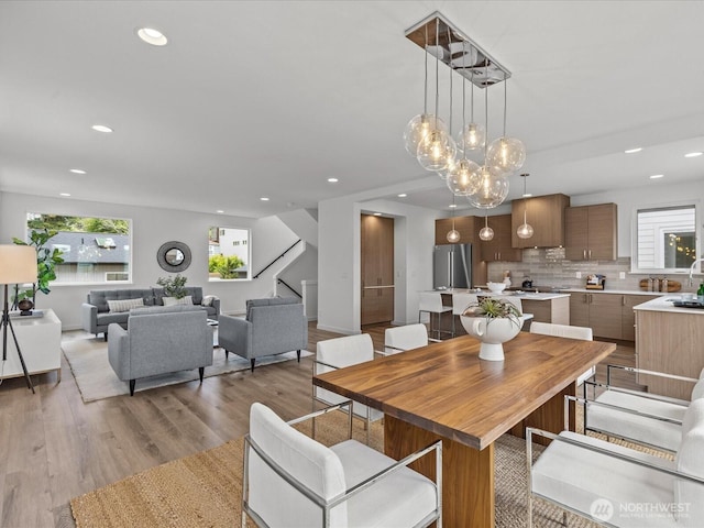 9015 Dibble Ave NW, Seattle, WA 98117 - dining room with recessed lighting, light wood finished floors, and stairway