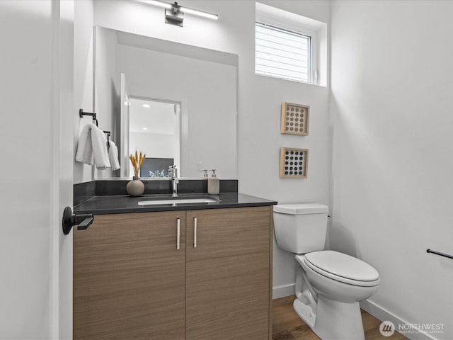 9015 Dibble Ave NW, Seattle, WA 98117 - half bath featuring vanity and wood finished floors