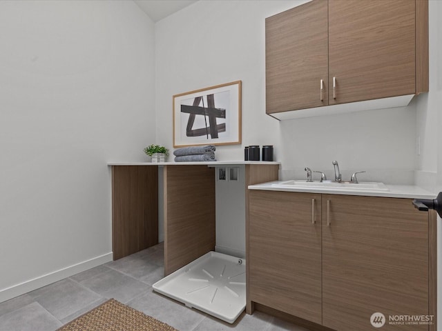 9015 Dibble Ave NW, Seattle, WA 98117 - laundry room featuring cabinet space and light tile patterned flooring