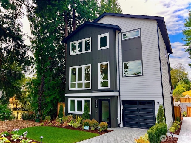 9015 Dibble Ave NW, Seattle, WA 98117 - contemporary house with decorative driveway, a garage, and board and batten siding