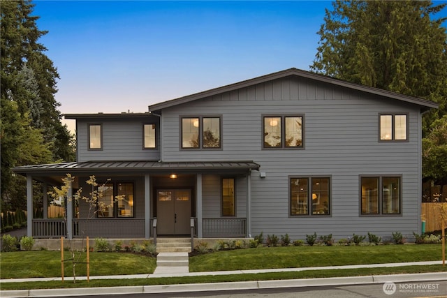 331 18th Ave, Kirkland, WA 98033 - view of front of house with a standing seam roof, a porch, a front yard, and a metal roof