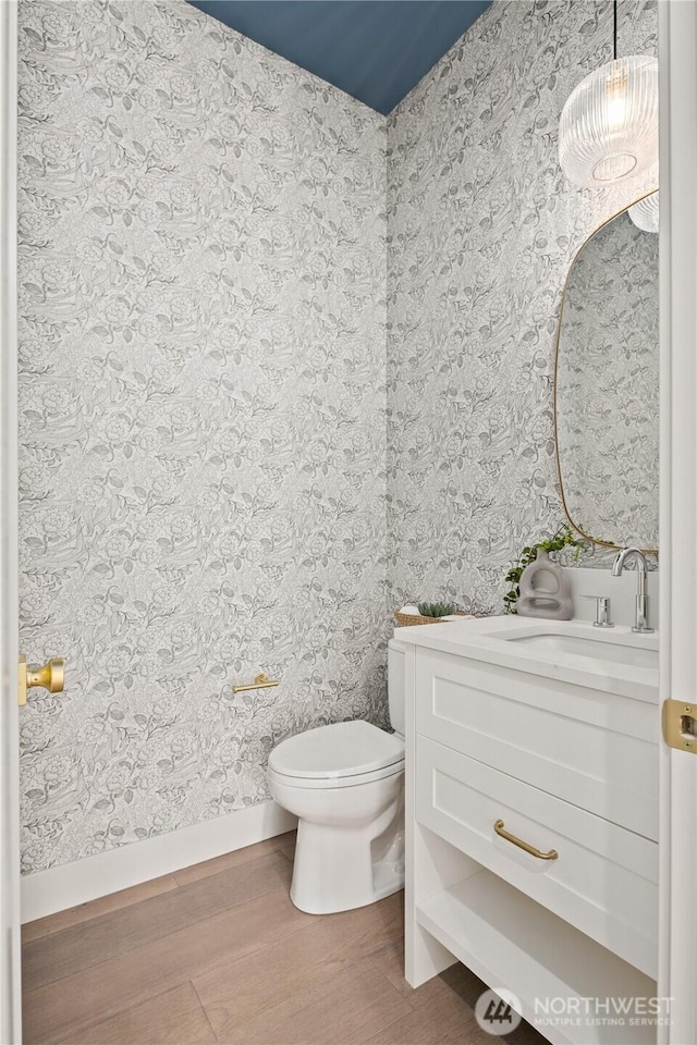 331 18th Ave, Kirkland, WA 98033 - half bathroom featuring wood finished floors, vanity, and wallpapered walls