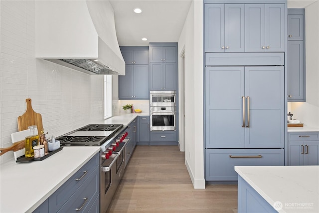 331 18th Ave, Kirkland, WA 98033 - kitchen featuring high quality appliances, premium range hood, light wood-style floors, recessed lighting, and light countertops