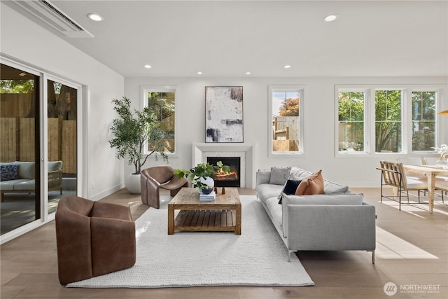 331 18th Ave, Kirkland, WA 98033 - living area with plenty of natural light, recessed lighting, a glass covered fireplace, and wood finished floors