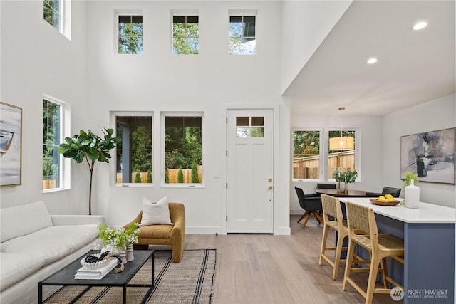 333 18th Ave, Kirkland, WA 98033 - living room featuring light wood-style flooring, a towering ceiling, and recessed lighting