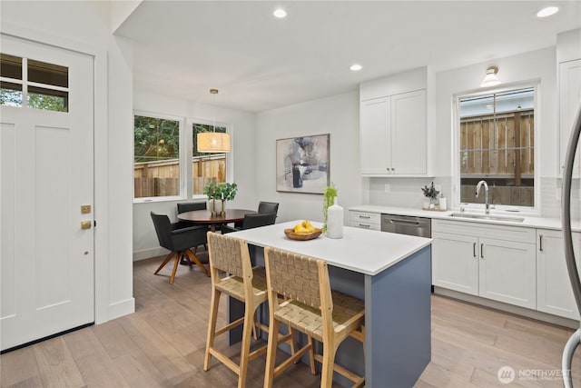 333 18th Ave, Kirkland, WA 98033 - kitchen with light countertops, white cabinetry, recessed lighting, light wood finished floors, and a breakfast bar area