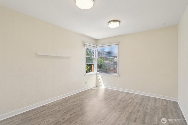 11303 Park Ave S, Tacoma, WA 98444 - spare room featuring wood finished floors and baseboards