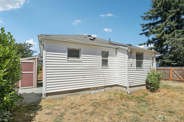 11303 Park Ave S, Tacoma, WA 98444 - rear view of property featuring a shingled roof and a storage shed