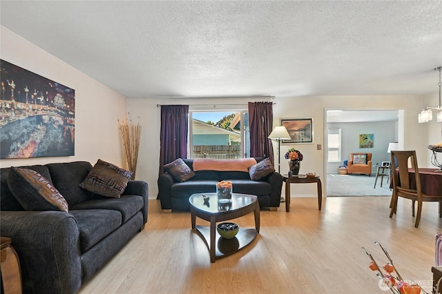 2102 35th Ave, Longview, WA 98632 - living area featuring a textured ceiling, light wood-style flooring, and a chandelier