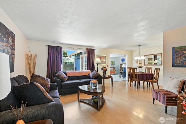 2102 35th Ave, Longview, WA 98632 - living room with a chandelier, light wood-type flooring, and a textured ceiling