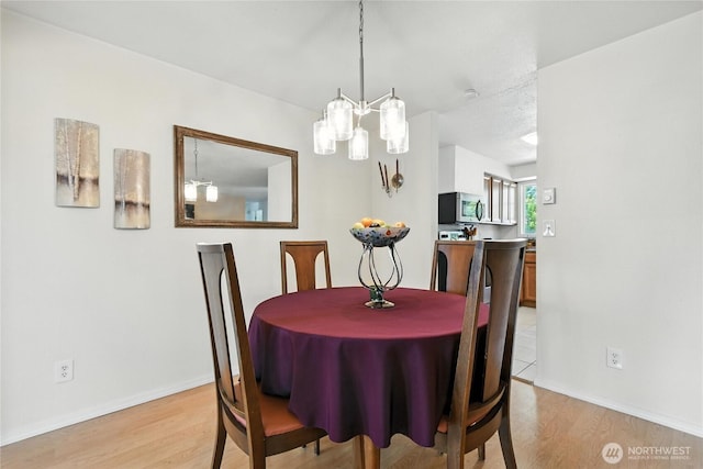 2102 35th Ave, Longview, WA 98632 - dining space featuring light wood-style flooring and a chandelier
