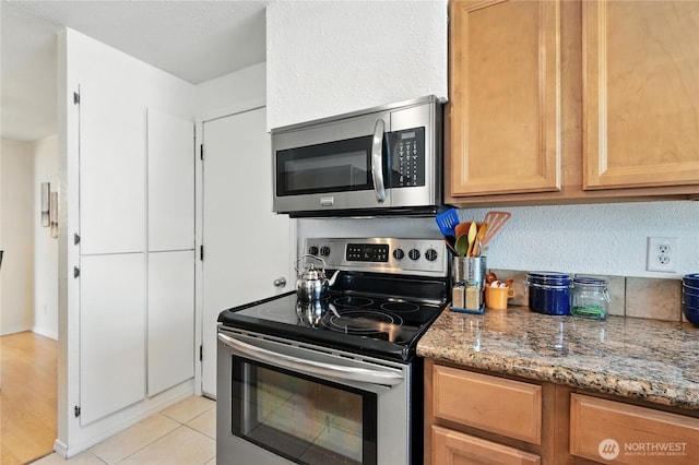 2102 35th Ave, Longview, WA 98632 - kitchen featuring appliances with stainless steel finishes, light stone counters, and light tile patterned flooring