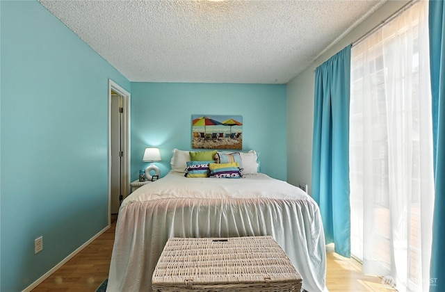 2102 35th Ave, Longview, WA 98632 - bedroom with a textured ceiling, multiple windows, and wood finished floors
