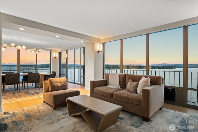 1620 43rd Ave E Unit 15A-B, Seattle, WA 98112 - living room featuring wood finished floors, a water view, and recessed lighting