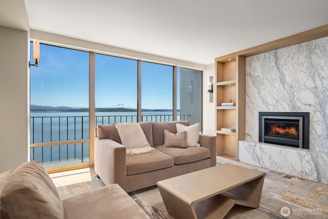 1620 43rd Ave E Unit 15A-B, Seattle, WA 98112 - living area with built in features, a water view, and a premium fireplace