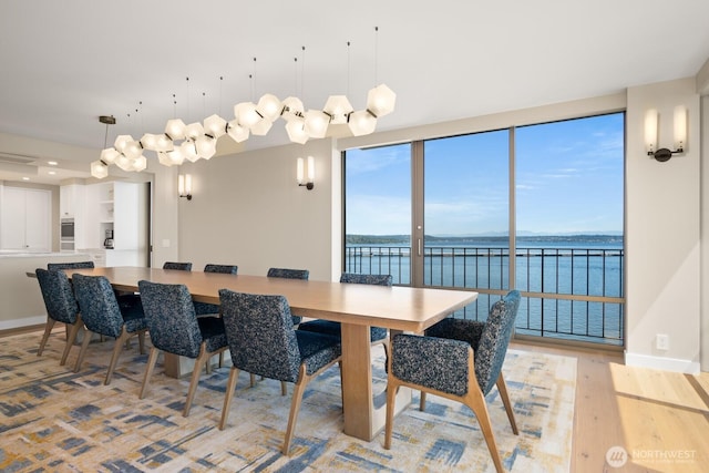 1620 43rd Ave E Unit 15A-B, Seattle, WA 98112 - dining space featuring a water view and light wood finished floors