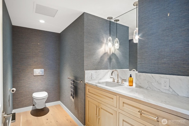 1620 43rd Ave E Unit 15A-B, Seattle, WA 98112 - bathroom with wood finished floors, vanity, and wallpapered walls