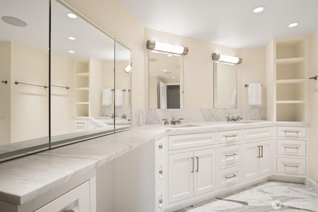 1620 43rd Ave E Unit 15A-B, Seattle, WA 98112 - bathroom with marble look tile flooring, double vanity, recessed lighting, and a closet