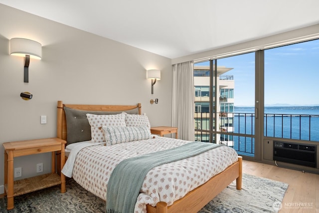1620 43rd Ave E Unit 15A-B, Seattle, WA 98112 - bedroom featuring access to outside, a water view, and wood finished floors