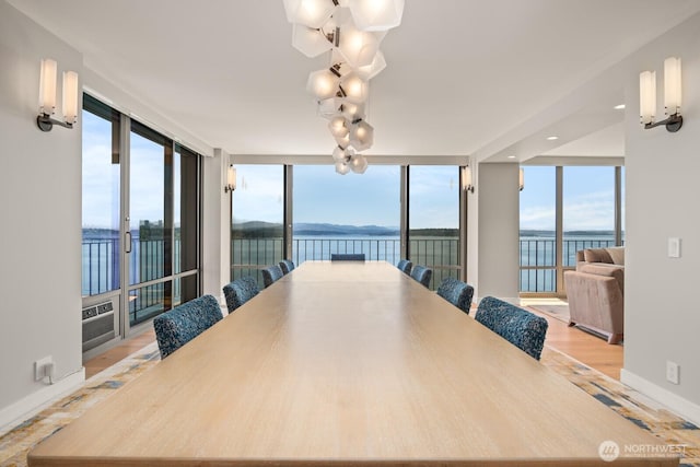 1620 43rd Ave E Unit 15A-B, Seattle, WA 98112 - dining room with a water view, plenty of natural light, and light wood-type flooring