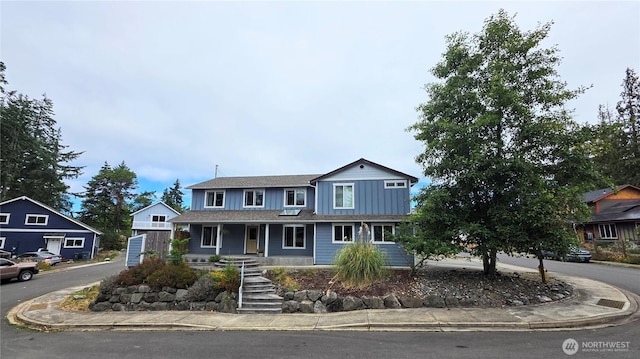 408 Eddy Ct, Port Townsend, WA 98368 - traditional-style home with board and batten siding, covered porch, and stairs