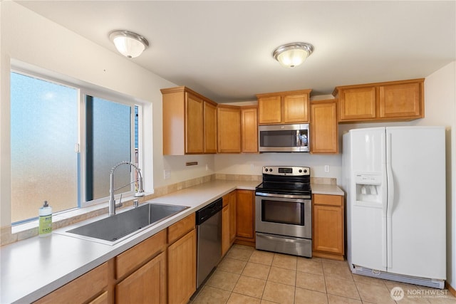408 Eddy Ct, Port Townsend, WA 98368 - kitchen featuring appliances with stainless steel finishes, light countertops, light tile patterned floors, and healthy amount of natural light