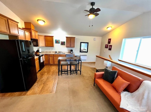408 Eddy Ct, Port Townsend, WA 98368 - kitchen featuring black appliances, lofted ceiling, ceiling fan, healthy amount of natural light, and brown cabinetry
