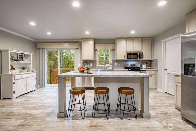 3563 Sweet Rd, Blaine, WA 98230 - kitchen with crown molding, a kitchen island, stainless steel appliances, decorative backsplash, and recessed lighting