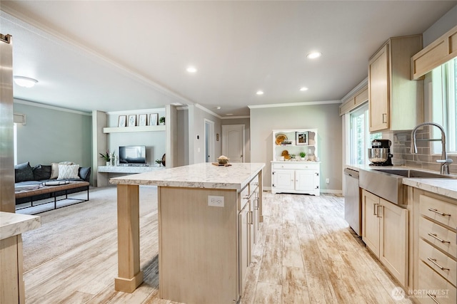 3563 Sweet Rd, Blaine, WA 98230 - kitchen featuring light brown cabinets, light wood-style flooring, ornamental molding, a center island, and light stone counters