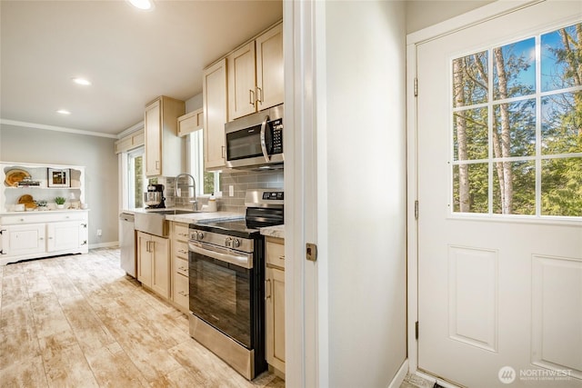 3563 Sweet Rd, Blaine, WA 98230 - kitchen featuring stainless steel appliances, tasteful backsplash, recessed lighting, light countertops, and crown molding