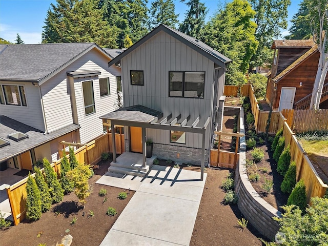 231 19th Ave, Kirkland, WA 98033 - view of front of house featuring board and batten siding, brick siding, a fenced backyard, and a shingled roof