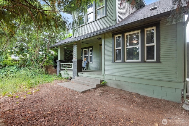 4061 E Howe St, Tacoma, WA 98404 - doorway to property with covered porch and roof with shingles