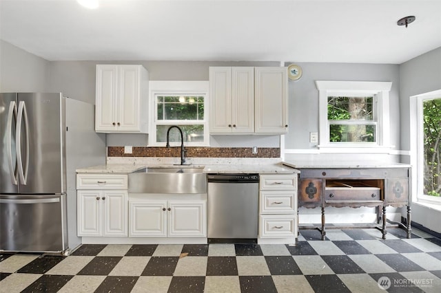 4061 E Howe St, Tacoma, WA 98404 - kitchen featuring appliances with stainless steel finishes, dark floors, white cabinets, and light stone counters