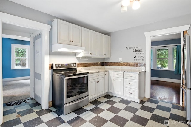 4061 E Howe St, Tacoma, WA 98404 - kitchen with stainless steel electric range oven, premium range hood, dark flooring, and white cabinets
